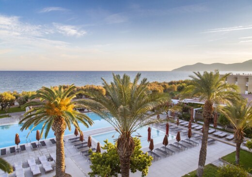 Collection of Doryssa luxury hotels in Samos main pools surrounded by palm trees