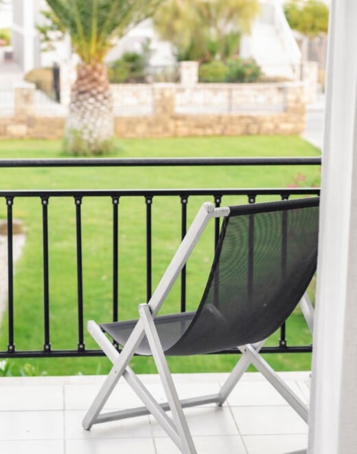 Chaise longue in balcony overlooking the lawn at Doryssa Coast's family apartments in Samos family apartments in Samos