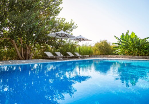 View of the main pool at Doryssa Coast with beachfront luxury apartments in Samos